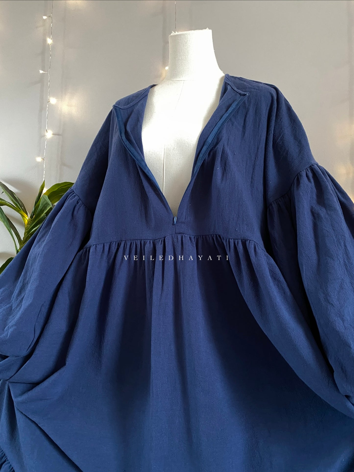 Mannequin wearing a navy blue colored organic 100% cotton abaya. Dark blue pure cotton abaya. Natural abaya with nursing friendly hidden zipper and deep pockets. Cute modest cotton abaya. All natural.