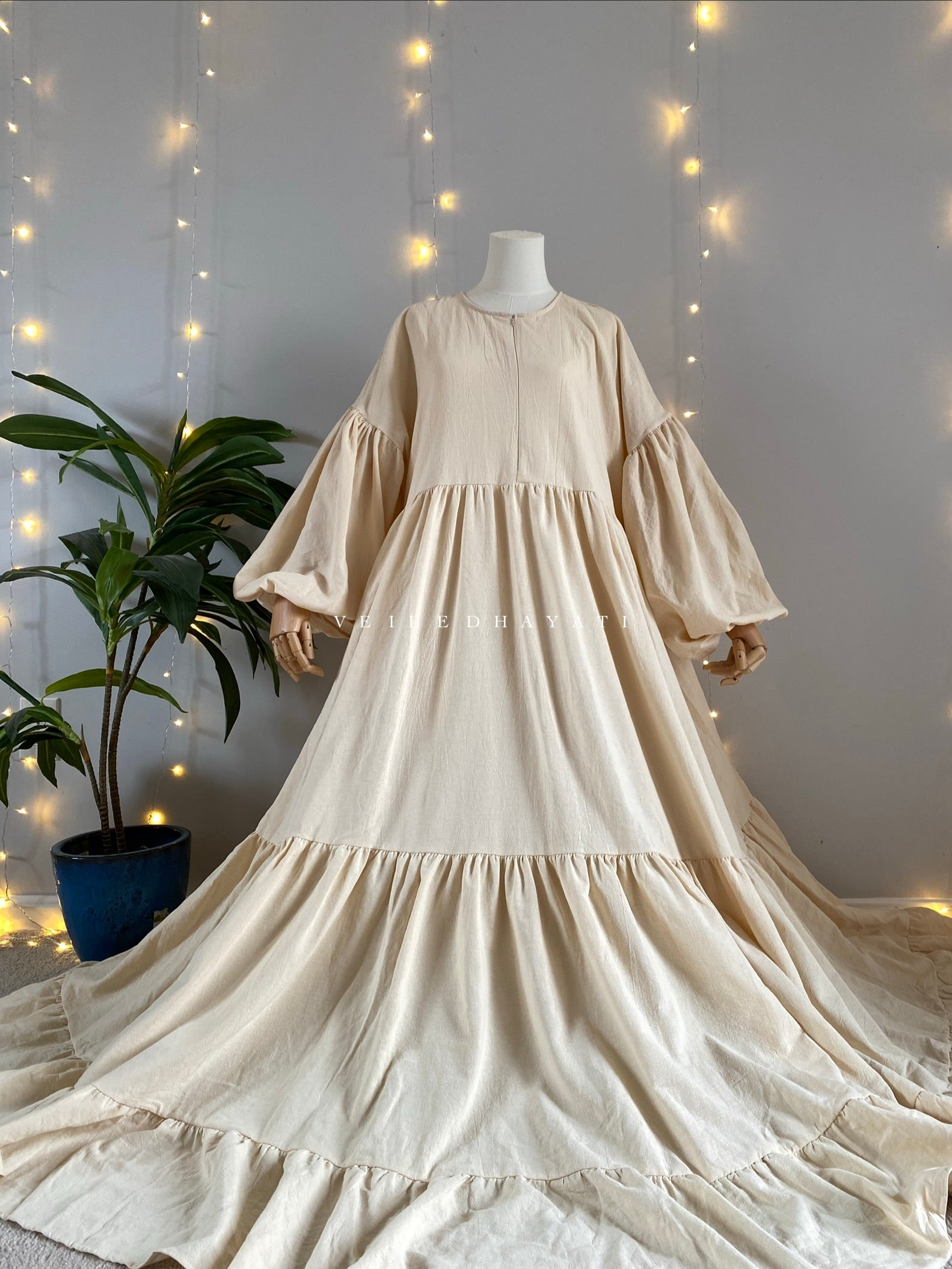 Mannequin wearing a cream creme colored organic 100% cotton abaya. Light beige pure cotton abaya. Natural abaya with nursing friendly hidden zipper and deep pockets. Cute modest cotton abaya. All natural.