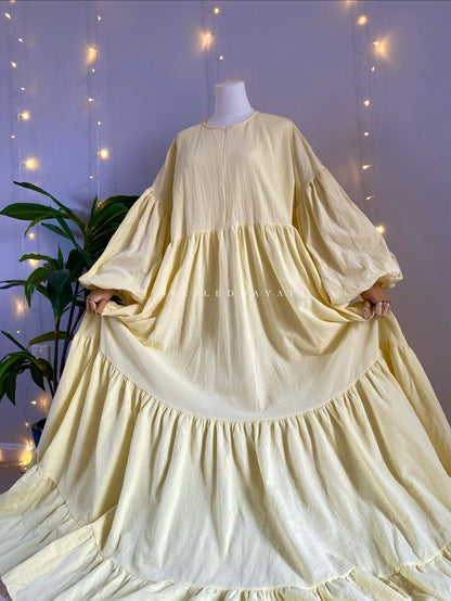 Mannequin wearing a butter yellow organic 100% cotton abaya. Pastel yellow pure cotton abaya. Natural abaya with nursing friendly hidden zipper and deep pockets. Cute modest cotton abaya. All natural.