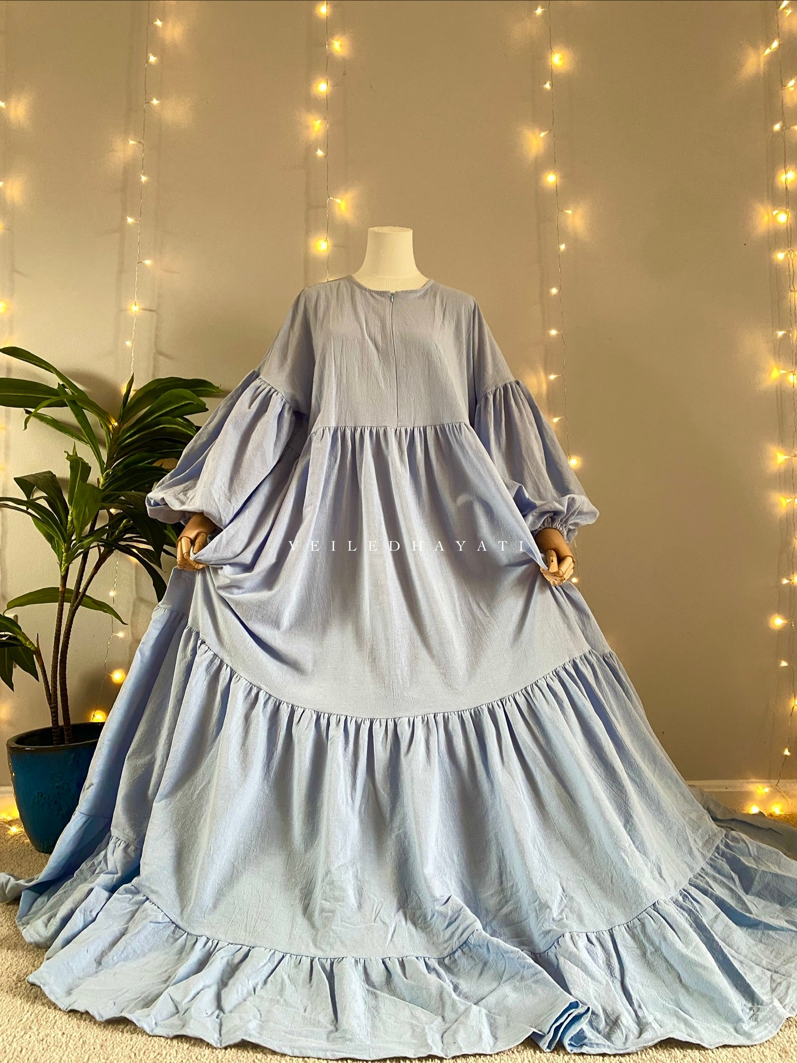 Mannequin wearing a pastel blue organic 100% cotton abaya. Light blue pure cotton abaya. Natural abaya with nursing friendly hidden zipper and deep pockets. Cute modest cotton abaya. All natural.