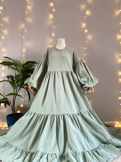 Mannequin wearing a pastel green organic 100% cotton abaya. Light green pure cotton abaya. Natural abaya with nursing friendly hidden zipper and deep pockets. Cute modest cotton abaya. All natural.