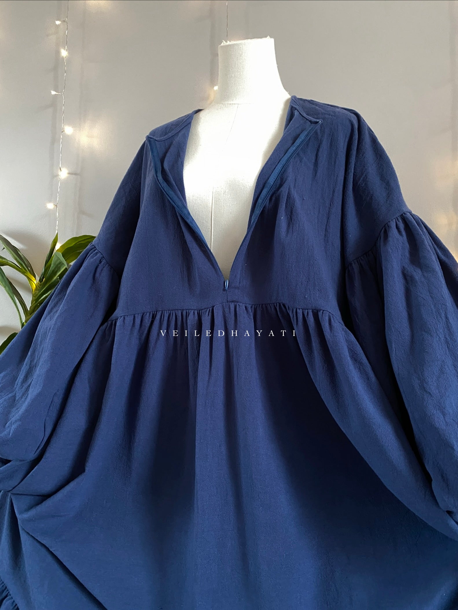 Mannequin wearing a navy blue colored organic 100% cotton abaya. Dark blue pure cotton abaya. Natural abaya with nursing friendly hidden zipper and deep pockets. Cute modest cotton abaya. All natural.